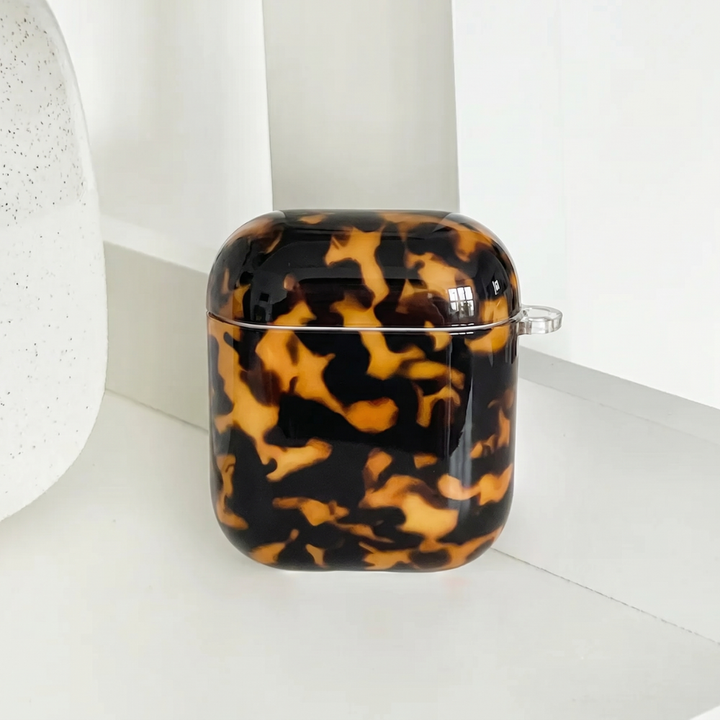 Tortoiseshell patterned case on a white background.