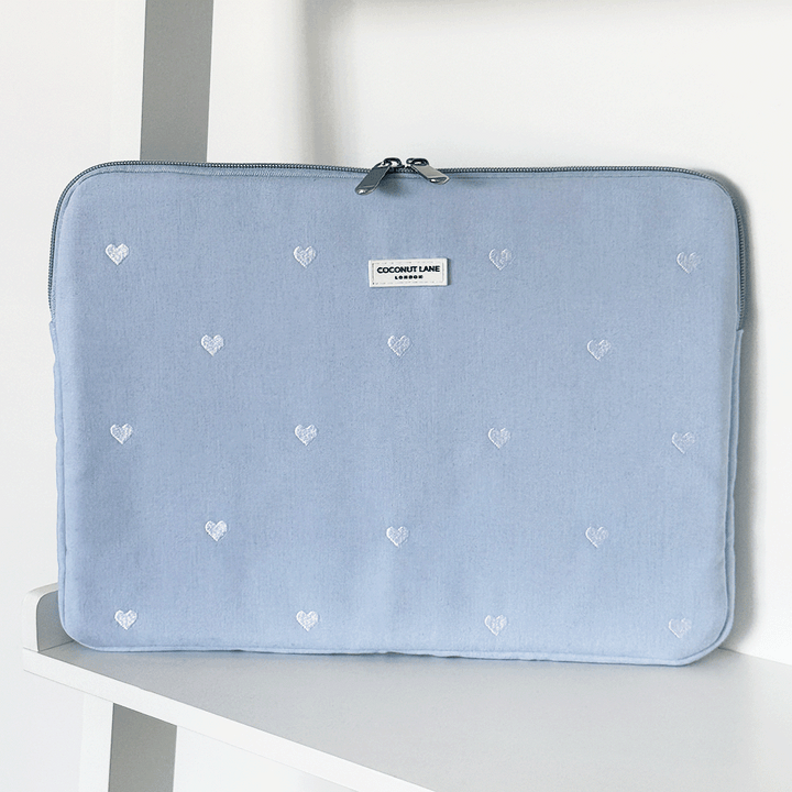 Blue fabric Laptop Sleeve with embroidered heart design.