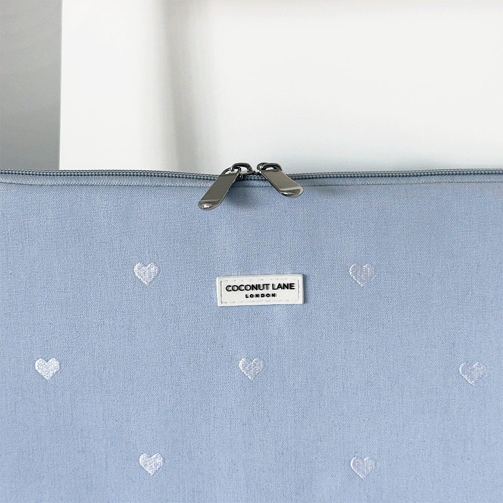 Blue fabric Laptop Sleeve with embroidered heart design.
