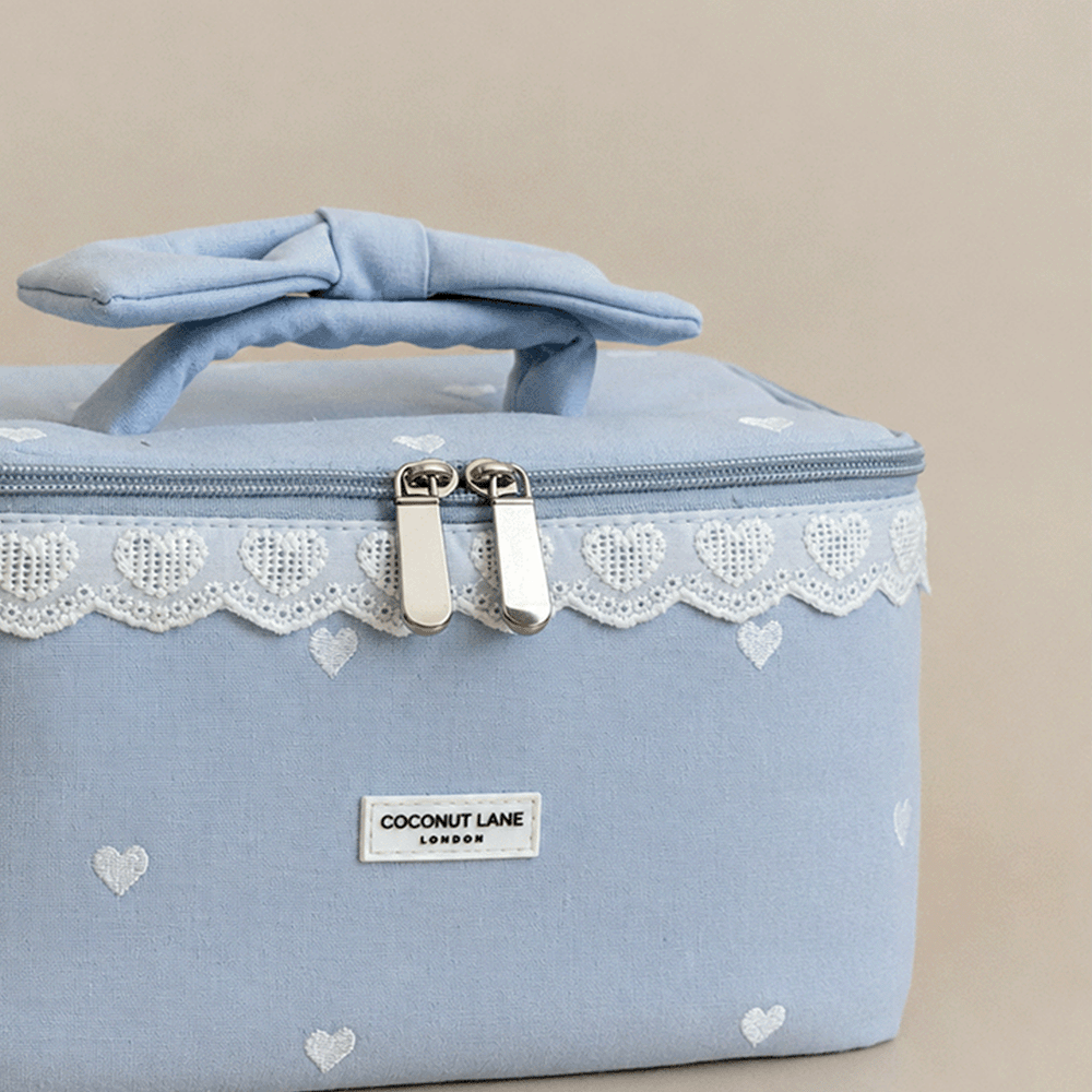 Light blue Vanity Bag with embroidered hearts. Lace trim and handle with bow.