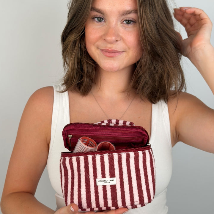 Girl playing with hair with her rollers in her mini vanity case