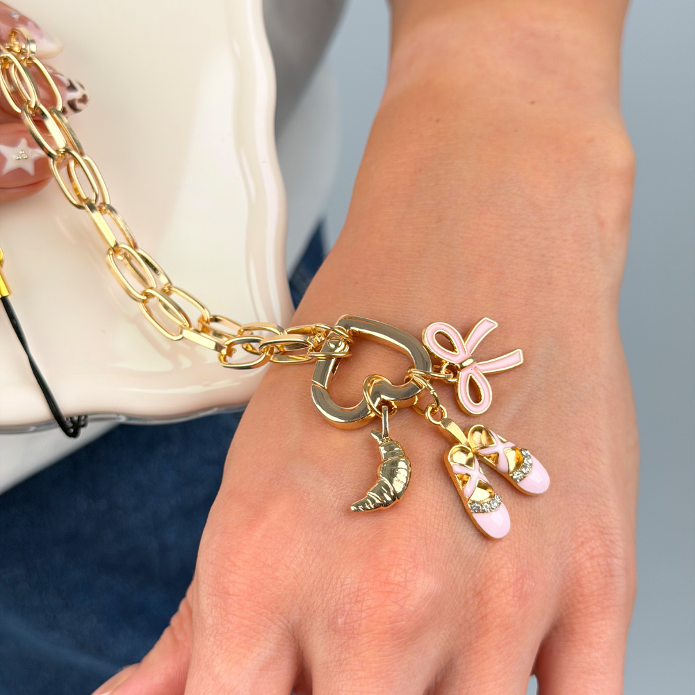 Pink Bow Charm on phone strap in lifestyle image