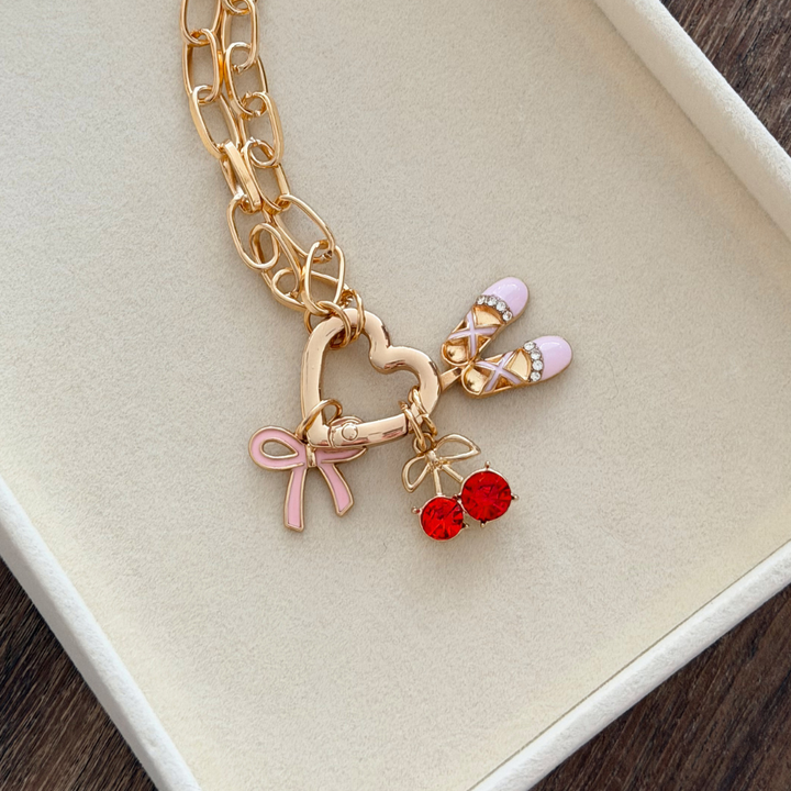 Pink Bow Phone Charm on jewellery tray on heart charm strap