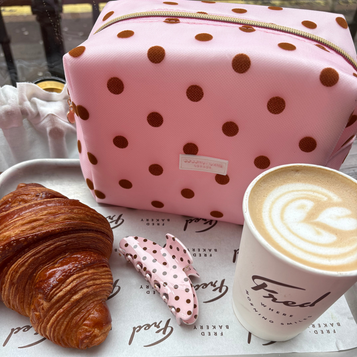 Dot Society Pink and Brown makeup bag with matching claw clip. Makeup bag is a sheer mesh pink material with brown polka dot detailing.