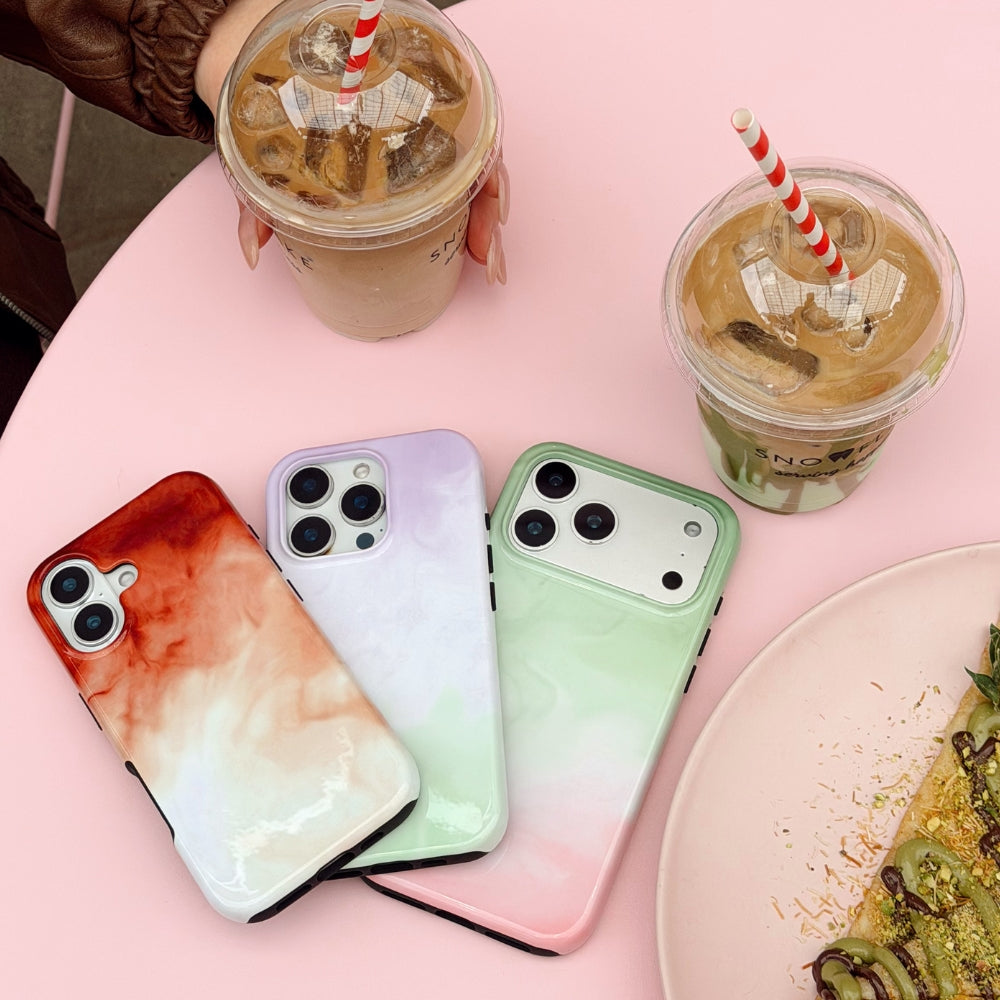 Collection of three dreamy drinks phone cases on a pink table with iced drinks and matcha crepe.