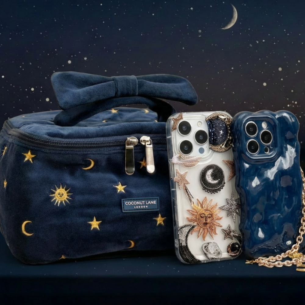 Navy bag with gold stars and two iPhones in Coconut Lane 3D bubble cases placed together on a dark surface.