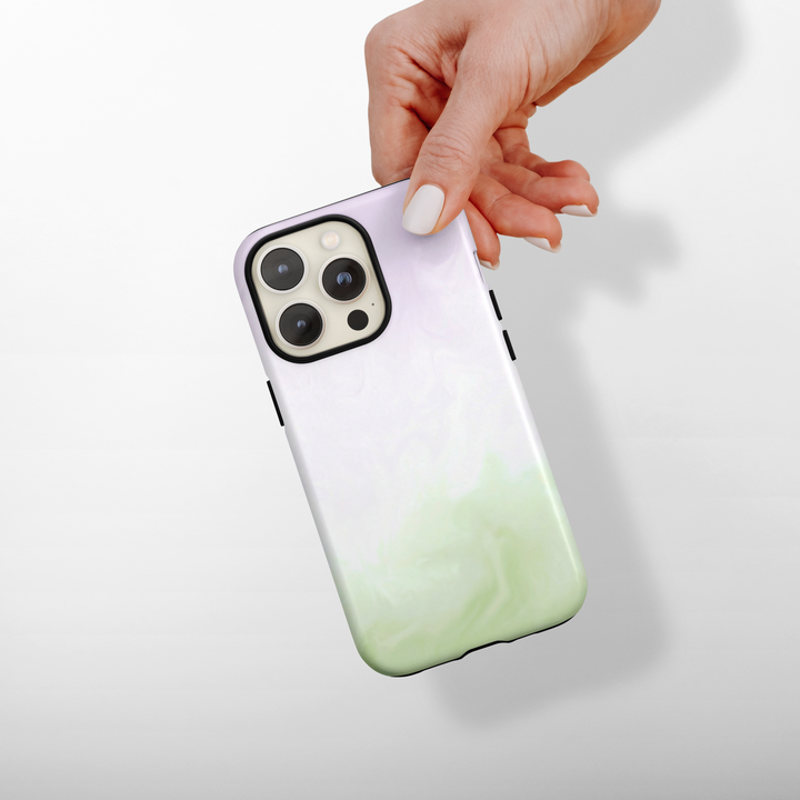 Phone case with a matcha and lavender gradient design held by a hand on a light background