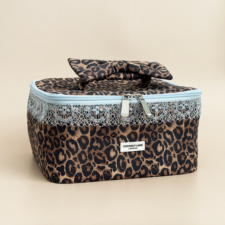 Coconut Lane Leopard Lace vanity case featuring brown leopard print, pale blue lace trim, double zip fastening and matching bow handle.