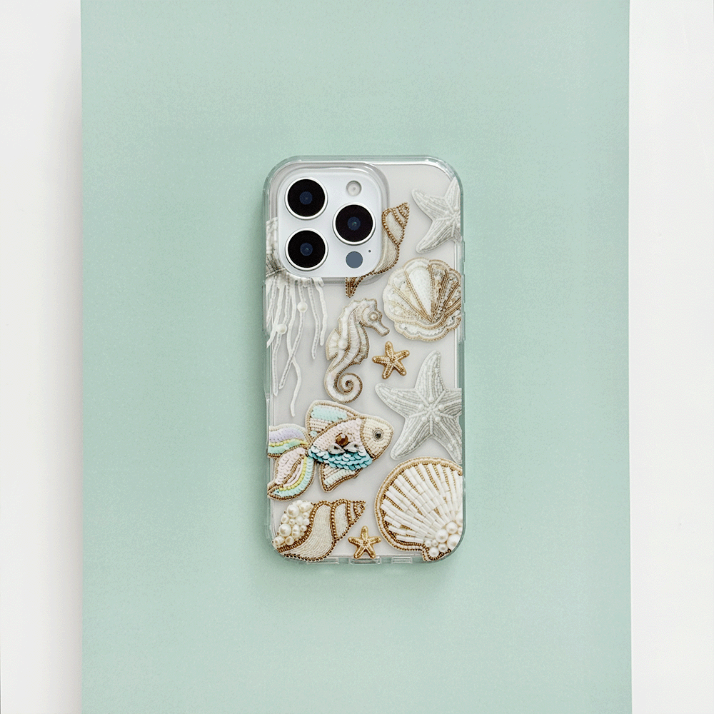 Clear phone case with beaded sea creatures and shells on a light green and white background.