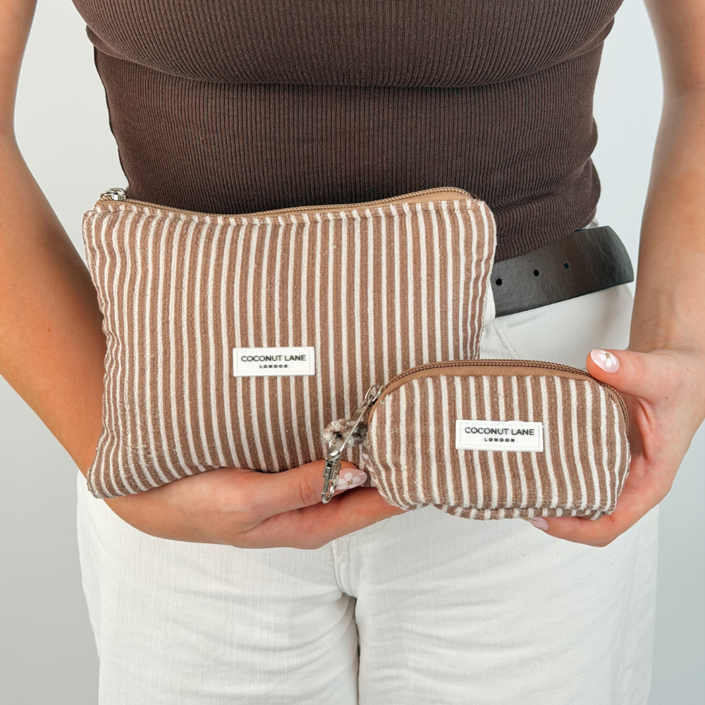 Girl holding two chestnut stripes makeup bags