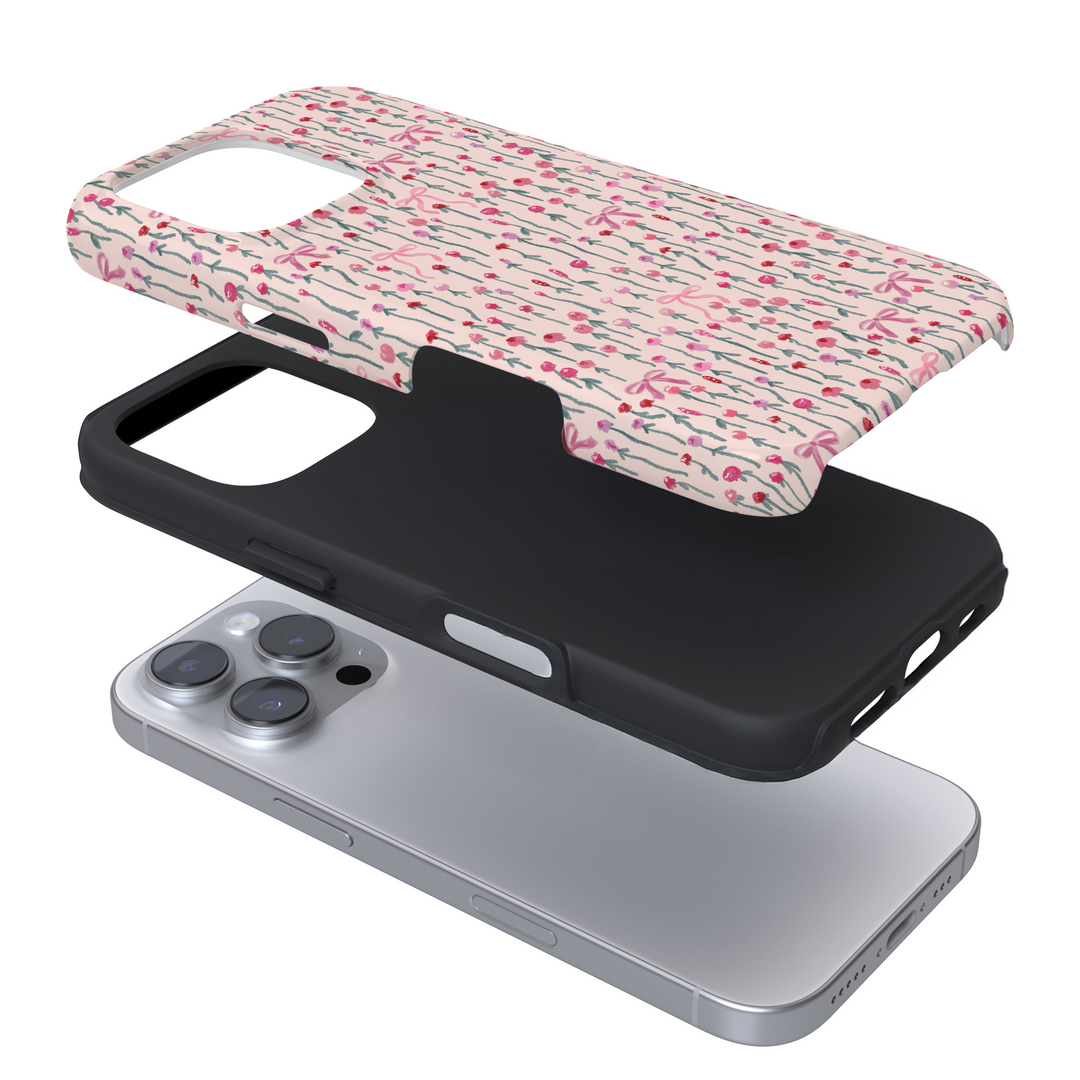 Expanded view of a phone case with a pink and bow floral pattern on a white background