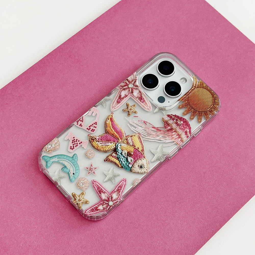 Coconut Lane clear phone case with pink trim and colorful embroidered patch designs.