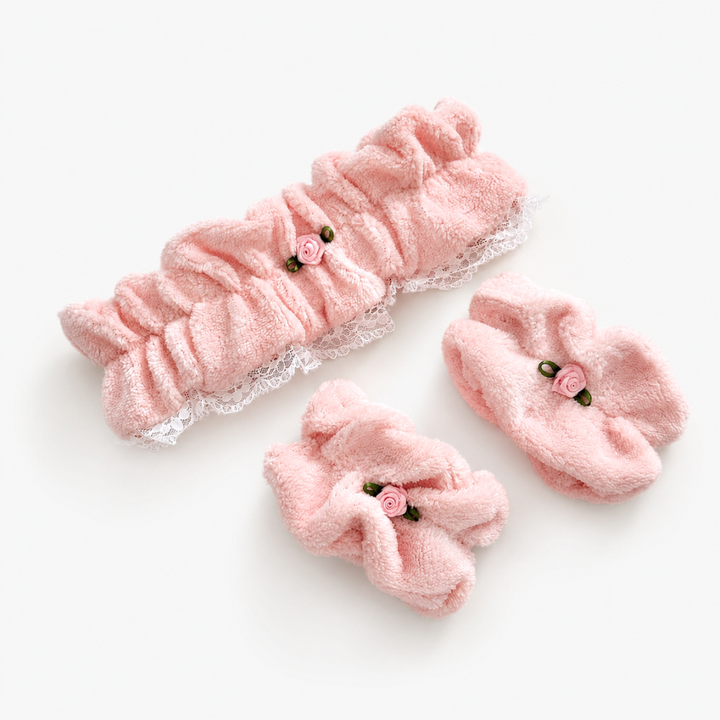 Pink pointelle fabric headband and wristbands with white lace trim detailing.