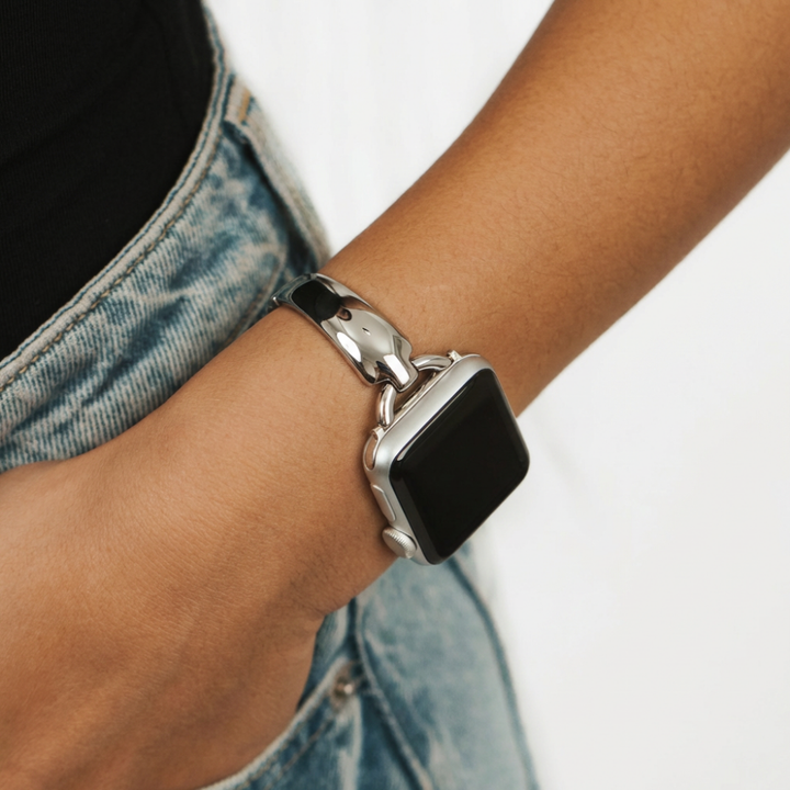 Silver bangle watch strap in blue jean pocket close up