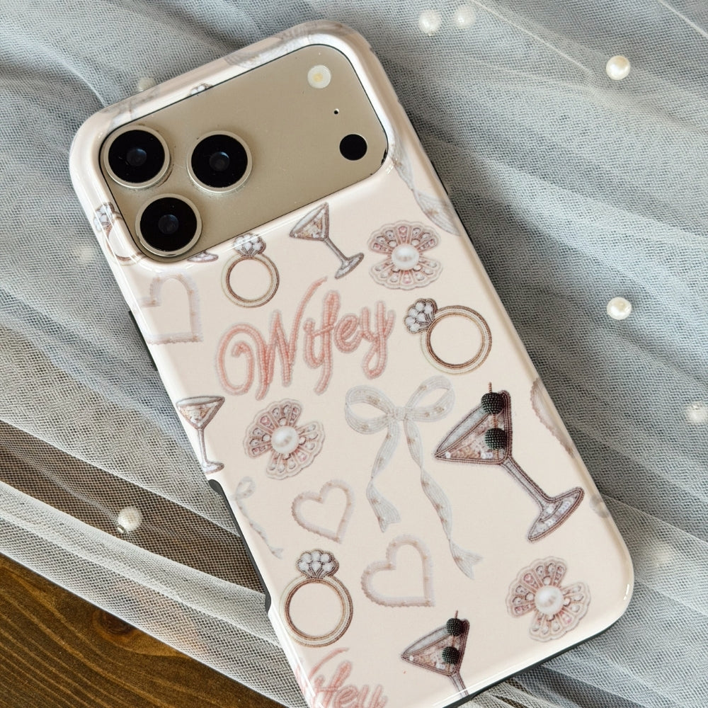 Light pink Phone case with 'Wifey' text and wedding-themed designs, laid on top of a sheer veil