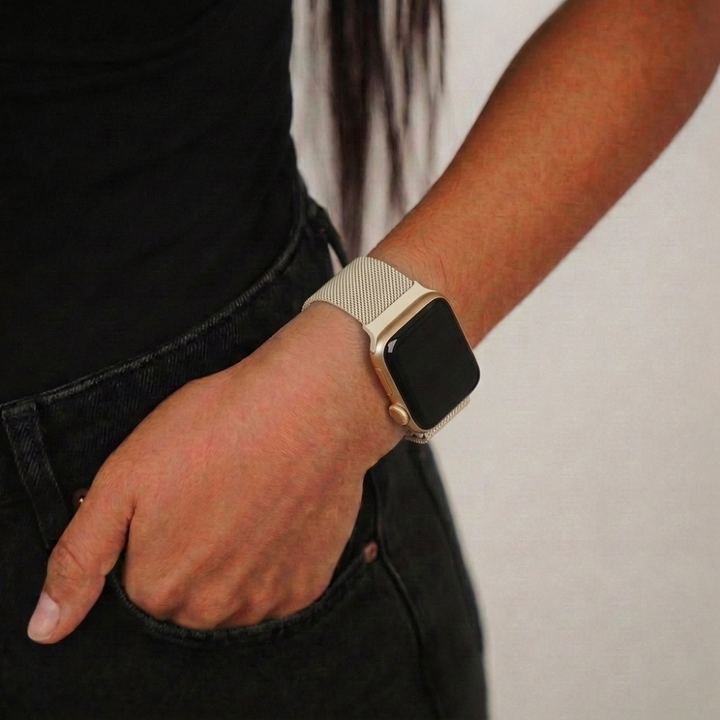 Girl wearing black and magnetic chain almond white apple watch strap on her wrist