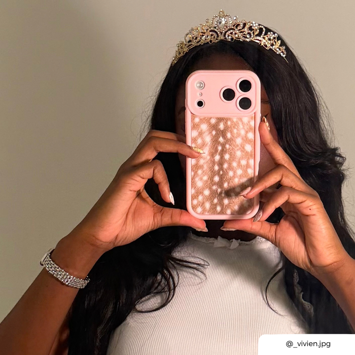 girl with dark hair wearing a tiara holding a pink and fawn print phone case