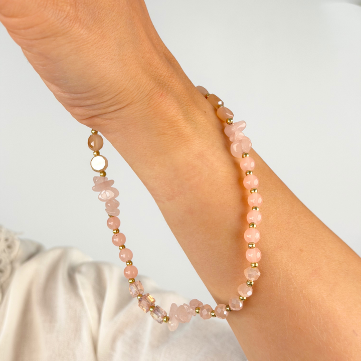 Girl with pink and gold phone strap on her wrist